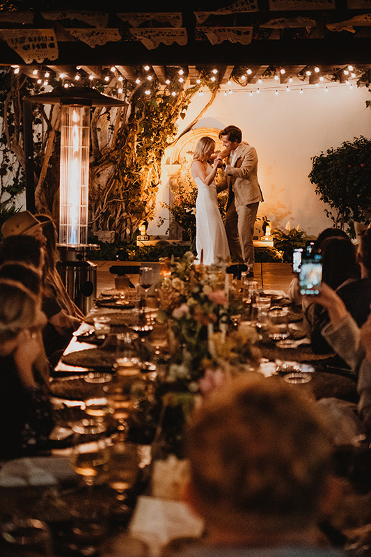 Couple sharing first dance at candlelit wedding reception in San Miguel de Allende, string lights overhead