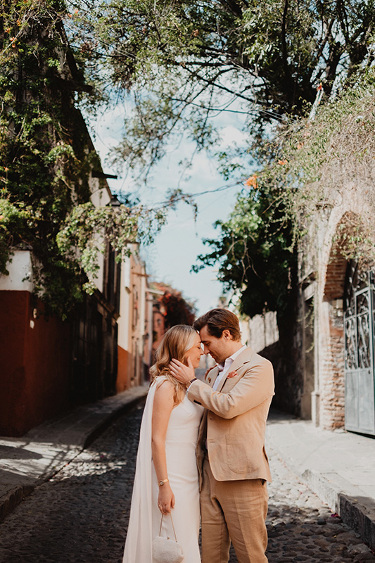 Bride and groom share an intimate moment on a cobblestone street in San Miguel de Allende during their wedding day