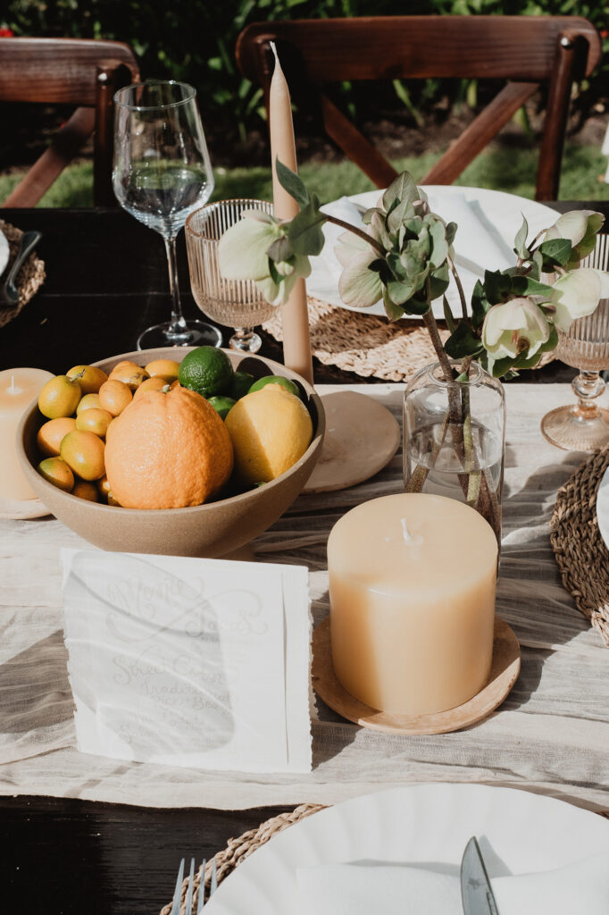 Wedding reception table with citrus bowl, candles, and white flowers in San Miguel de Allende