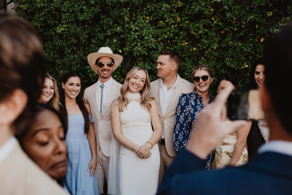 Wedding guests laughing and posing for a photo at a San Miguel de Allende reception, documentary style