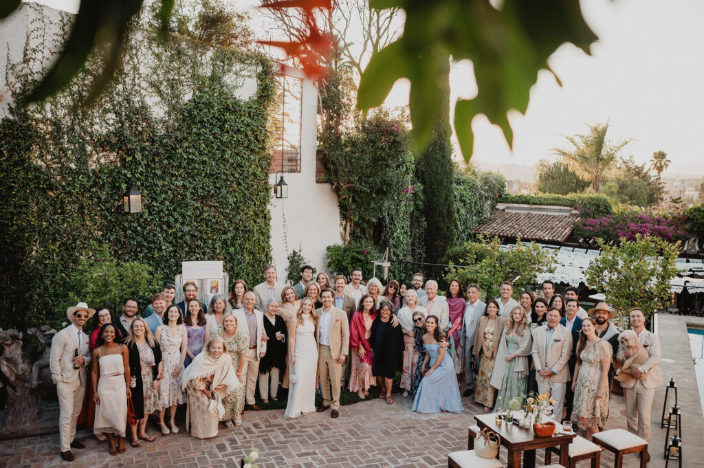 Wedding group photo at ivy-covered villa in San Miguel de Allende, documentary style by Alex Obregón