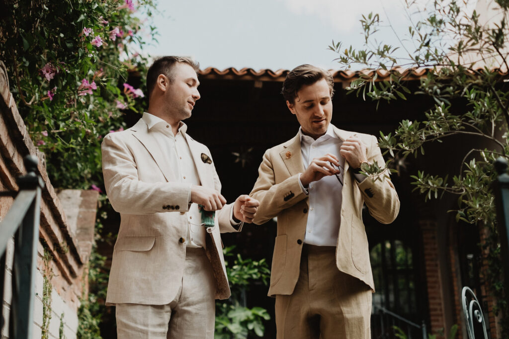 Two grooms adjusting suits before wedding ceremony, San Miguel de Allende, documentary wedding photography