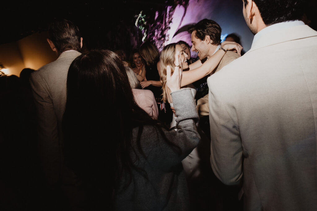Couple dancing and laughing together at wedding reception, San Miguel de Allende, documentary film photography