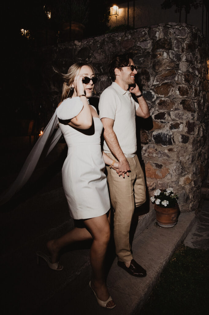 Couple holding hands at night during wedding reception, San Miguel de Allende, documentary film photography