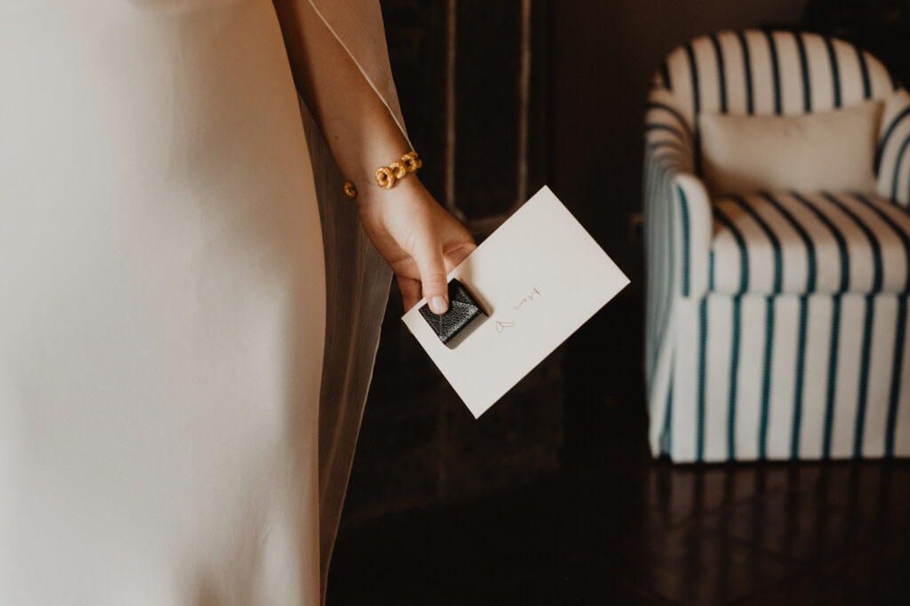 Bride holding a gift card and small box at her San Miguel de Allende wedding, documentary film photography