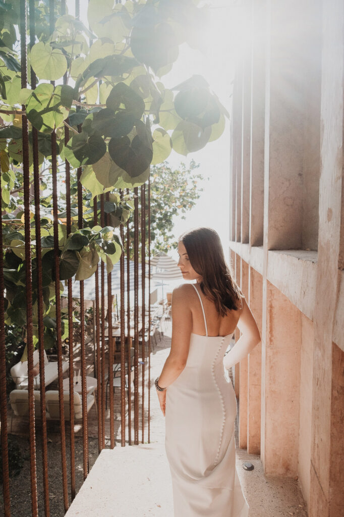 Bride in white slip dress at Rosa Morada, San Pancho elopement, golden backlight, lush vines