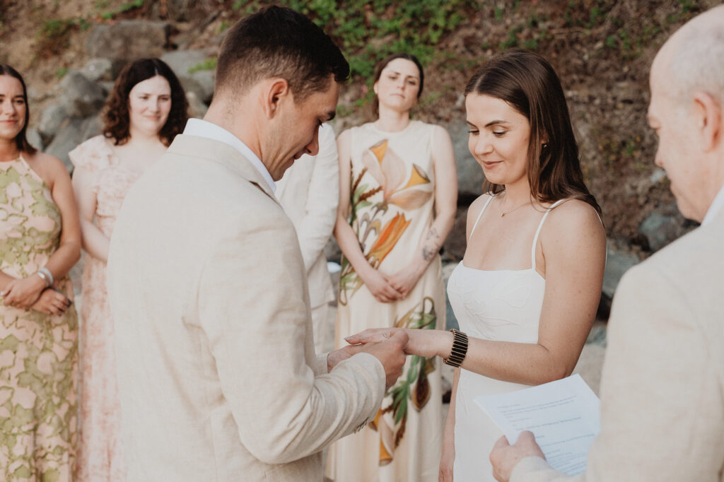 Groom placing wedding ring on bride's hand during elopement ceremony at Rosa Morada, San Pancho, Mexico