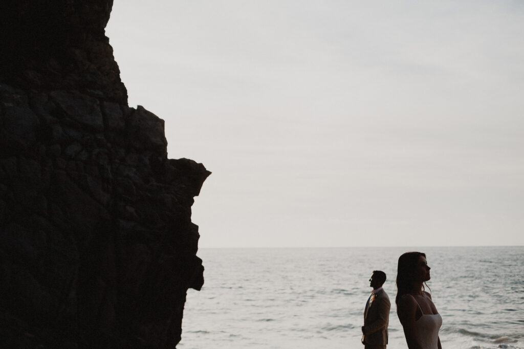 Elopement couple silhouetted by sea cliffs at sunset, Rosa Morada San Pancho, Mexico