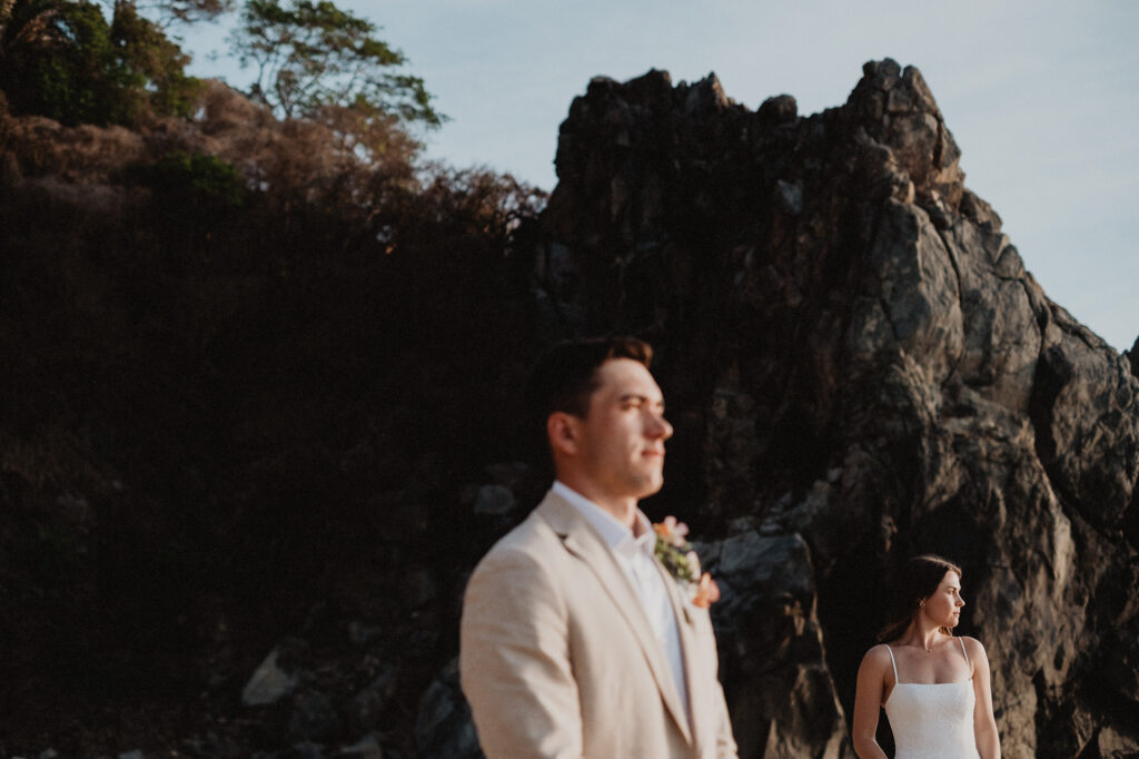 Elopement couple in white dress and linen suit at rocky cliffs, San Pancho Mexico golden hour