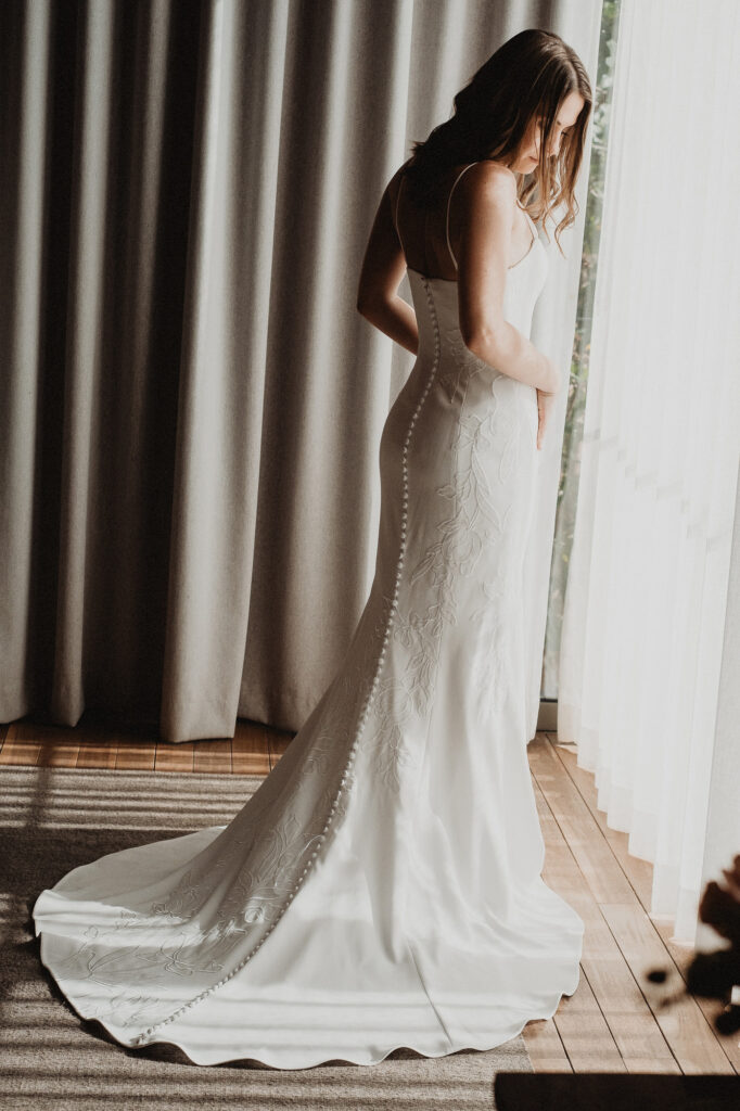 Bride in fitted white gown with floral train at Rosa Morada, San Pancho elopement