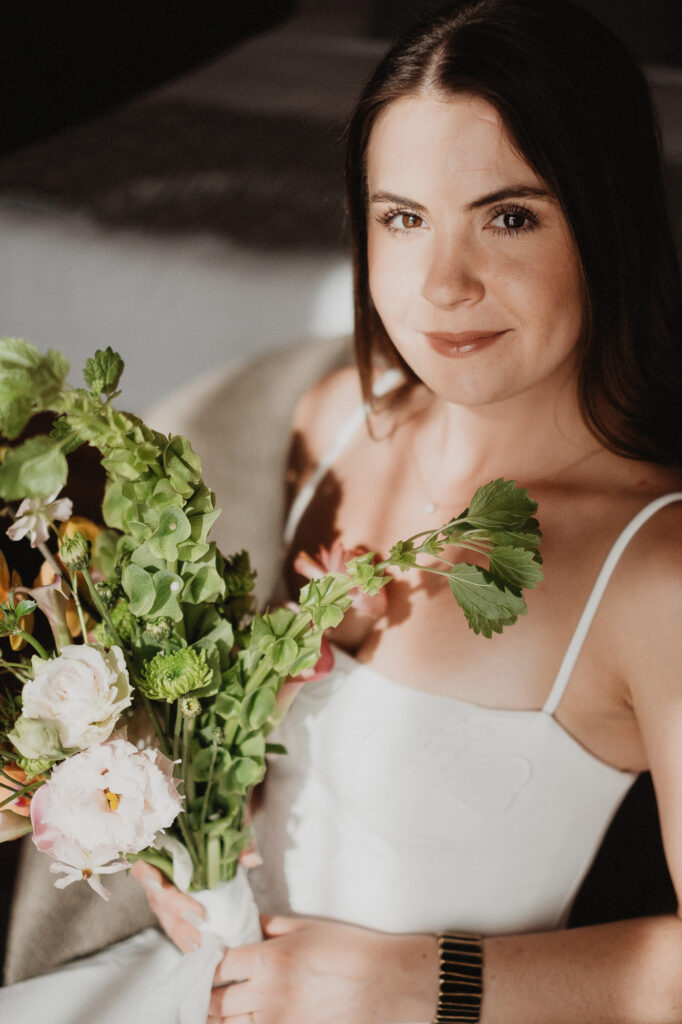 Bride holding lush floral bouquet during elopement in San Pancho, Rosa Morada, Mexico