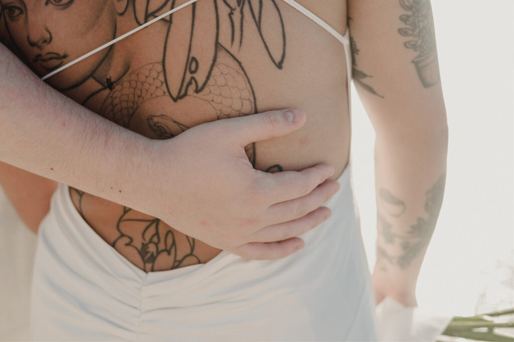 Tattooed couple embracing at elopement in Sayulita, Mexico, captured by destination wedding photographer