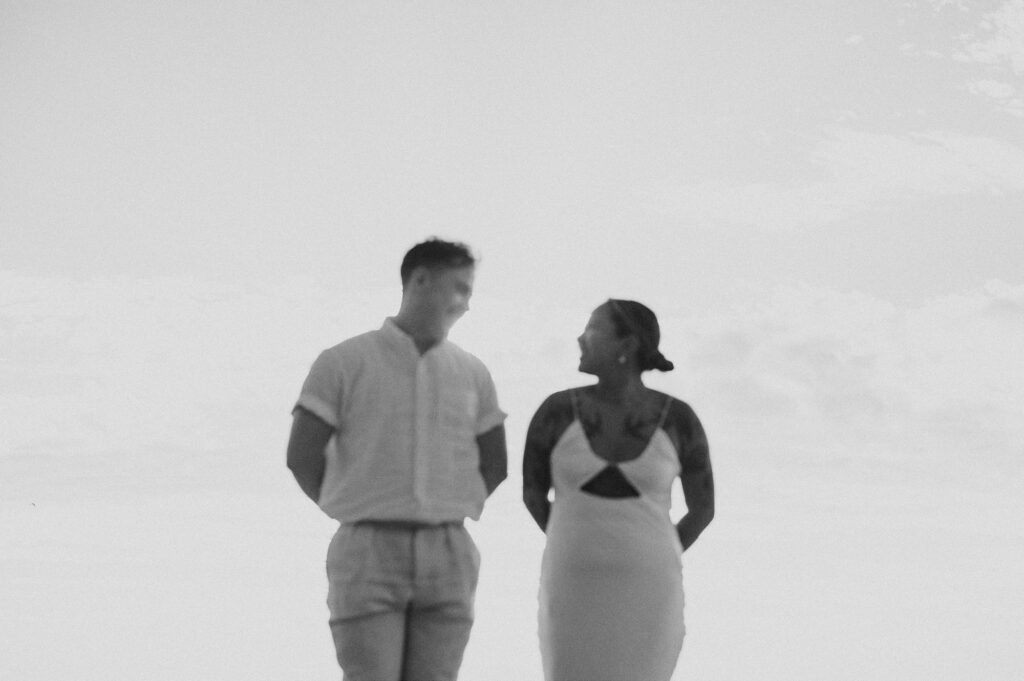 Couple sharing a laugh during elopement session at Villa Amor Sayulita, black and white film photo