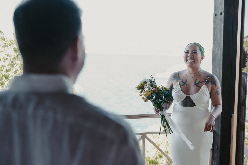 Bride laughing in white gown holding bouquet during elopement at Villa Amor, Sayulita, Mexico
