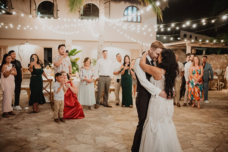 Bride and groom share first dance at Villa Valentin Sayulita wedding reception, guests watching under string lights
