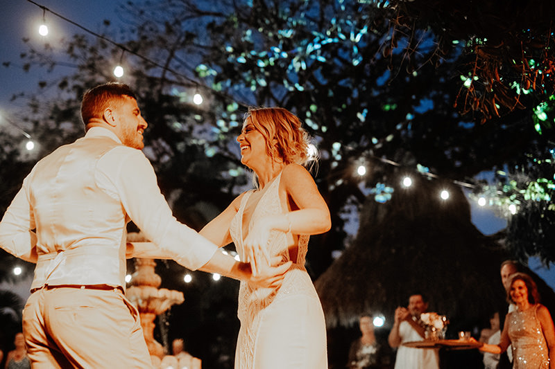 Bride and groom share joyful first dance at Villa Amor Sayulita wedding reception under string lights