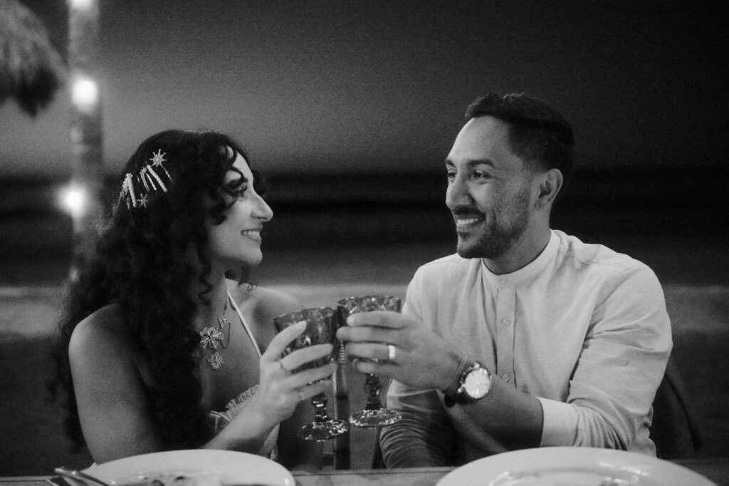 Couple toasting at wedding reception, Frente al Punto Sayulita, documentary wedding photography by Alex Obregón