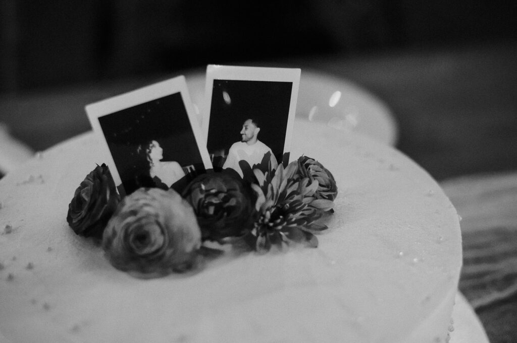 Wedding cake with Polaroid photos and flowers at Frente al Punto, Sayulita reception