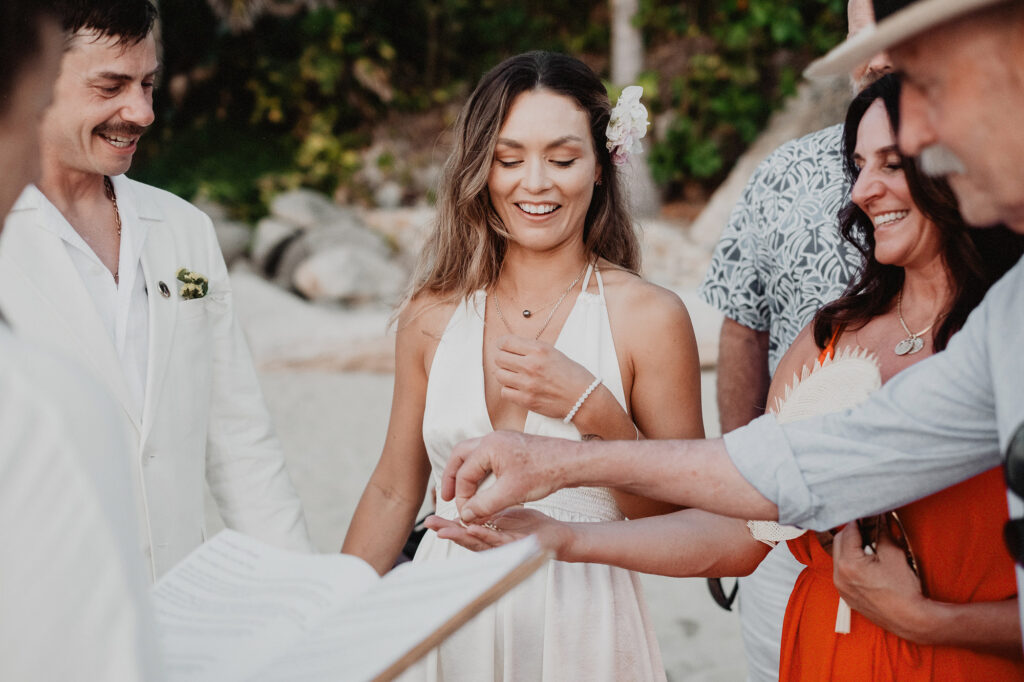 Bride laughing during ring exchange at beach wedding ceremony, Villa del Sol Sayulita