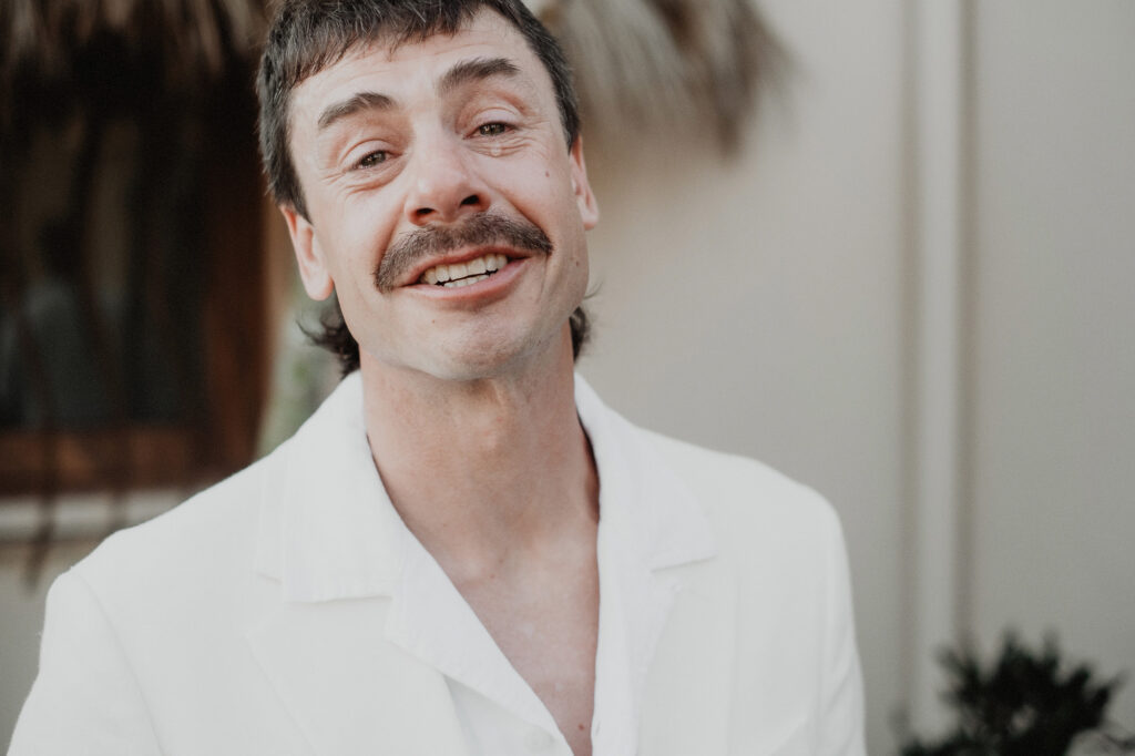 Groom smiling during wedding ceremony at Villa del Sol, Sayulita, photographed by Alex Obregón