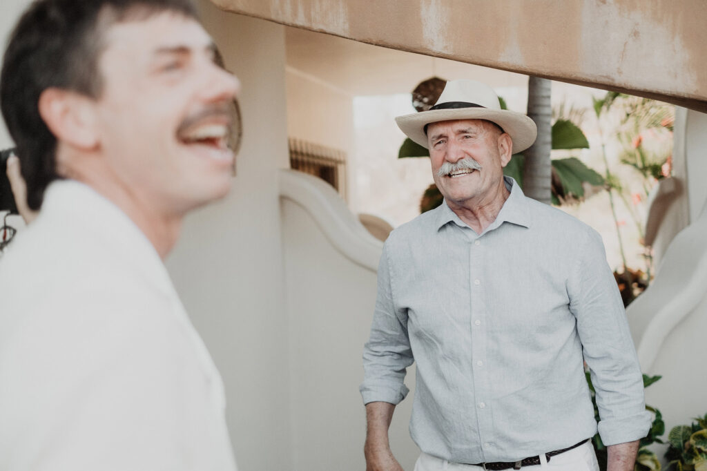Father and son laughing together before wedding ceremony at Villa del Sol Sayulita