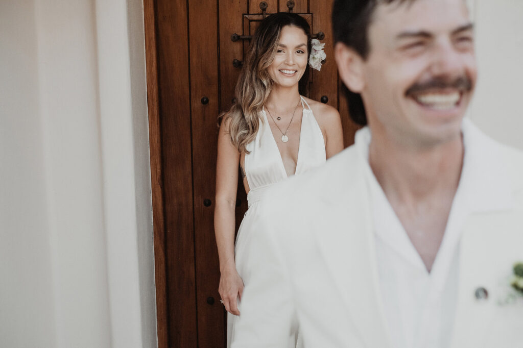 Bride smiling in white halter dress at Villa del Sol doorway, Sayulita wedding ceremony