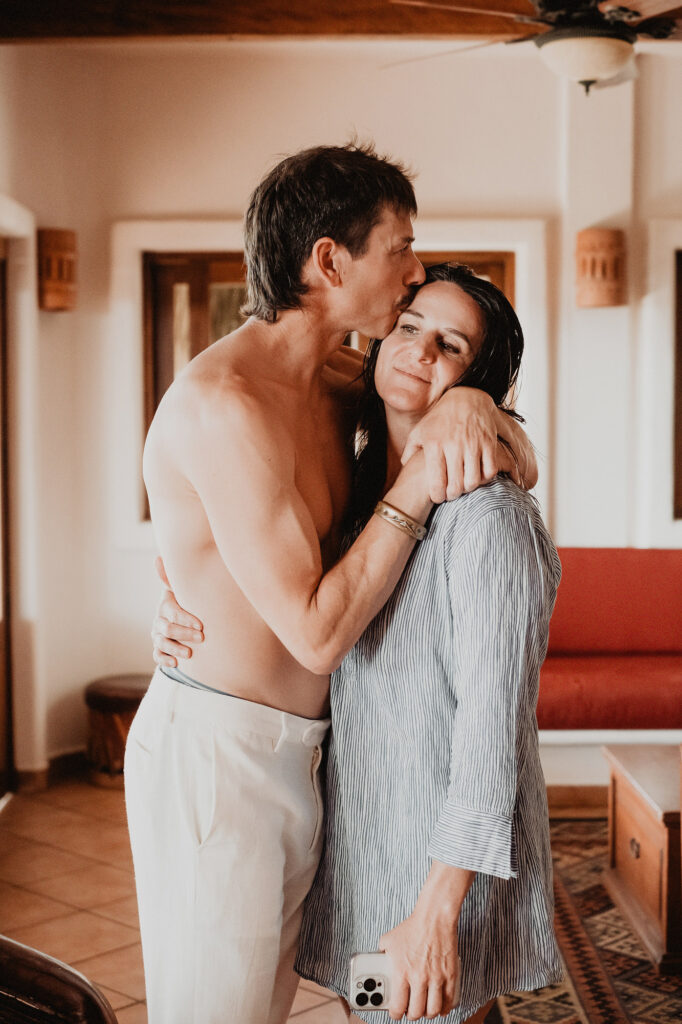 Couple embracing and kissing at Villa del Sol Sayulita wedding, documentary style photo by Alex Obregón