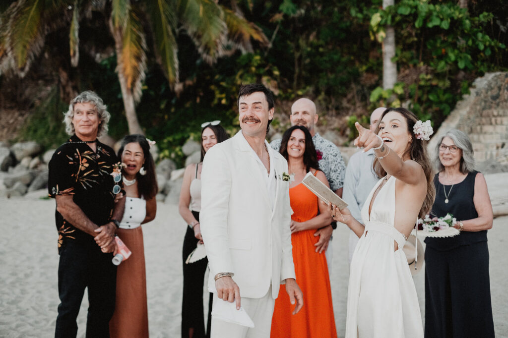 Bride and groom laughing on the beach during wedding ceremony at Villa del Sol, Sayulita, Mexico