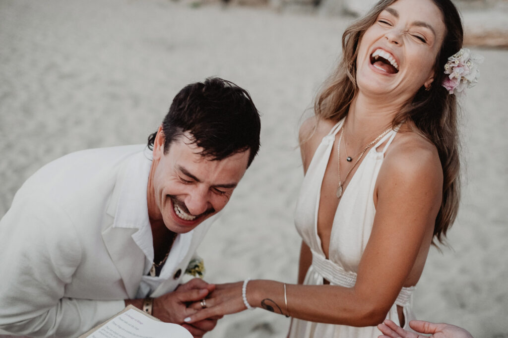 Couple laughing during wedding ceremony on the beach at Villa del Sol, Sayulita, Mexico