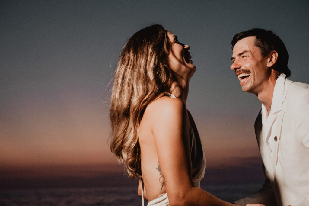 Couple laughing at sunset during wedding reception at Villa del Sol, Sayulita, photographed by Alex Obregón
