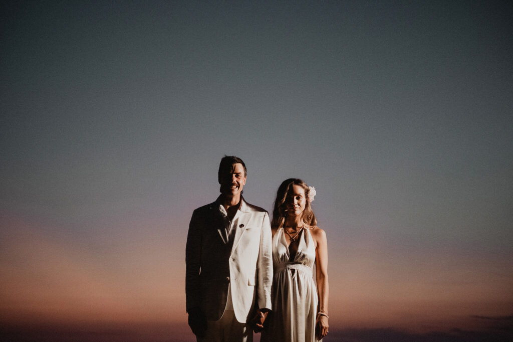 Couple holds hands at sunset during wedding reception at Villa del Sol, Sayulita, Mexico