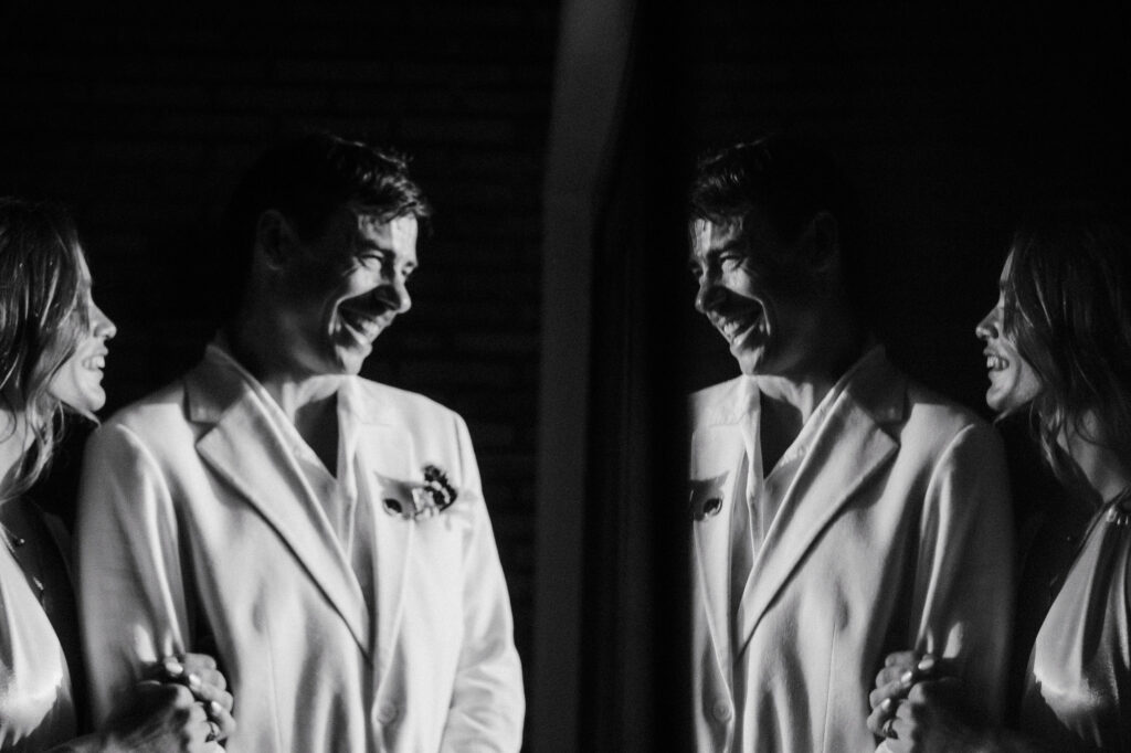 Groom laughing with bride at Villa del Sol Sayulita wedding ceremony, black and white film photo