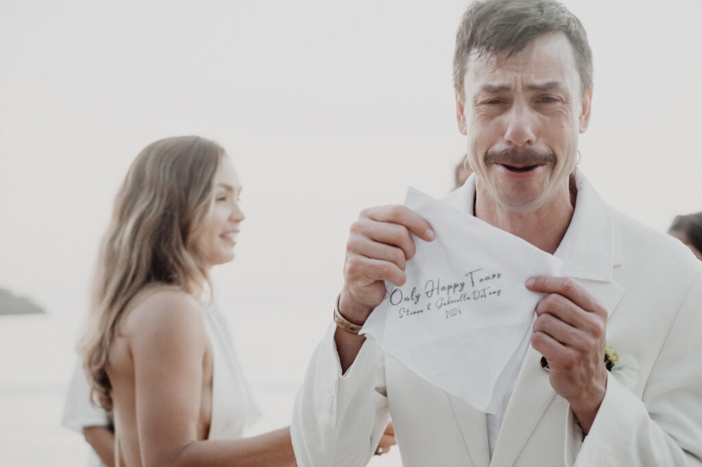 Groom crying happy tears holding personalized handkerchief at beach wedding ceremony, Sayulita Mexico 2024