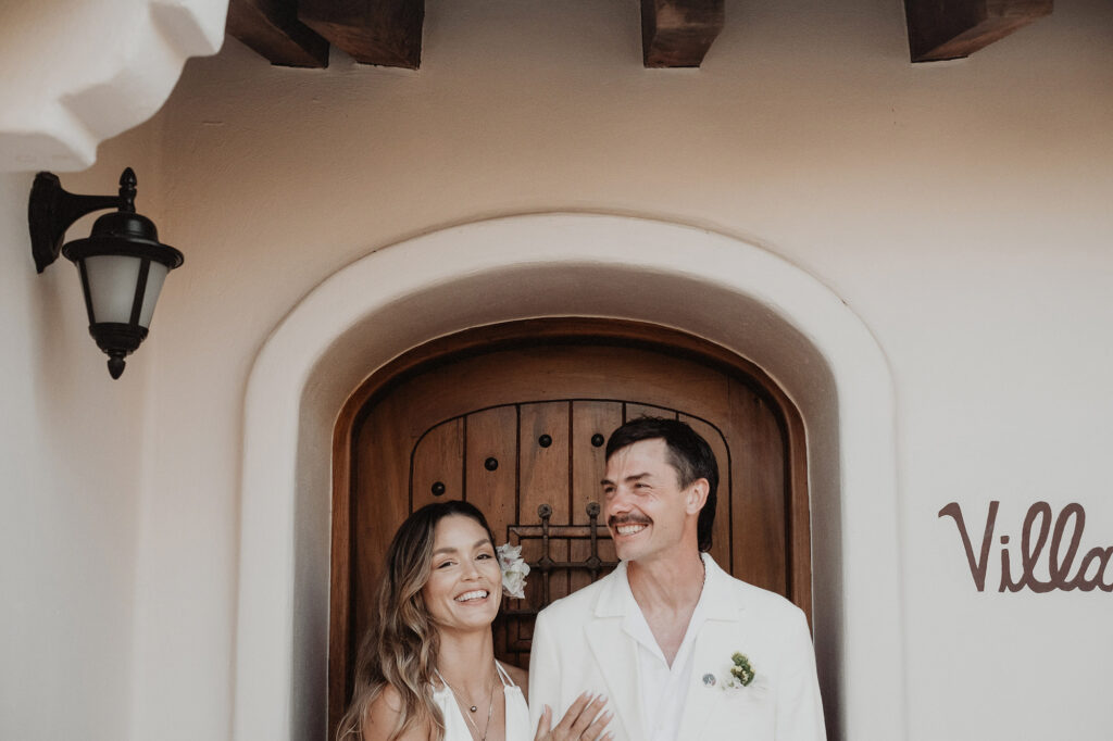 Bride and groom laughing together at Villa del Sol entrance, Sayulita wedding ceremony, documentary style