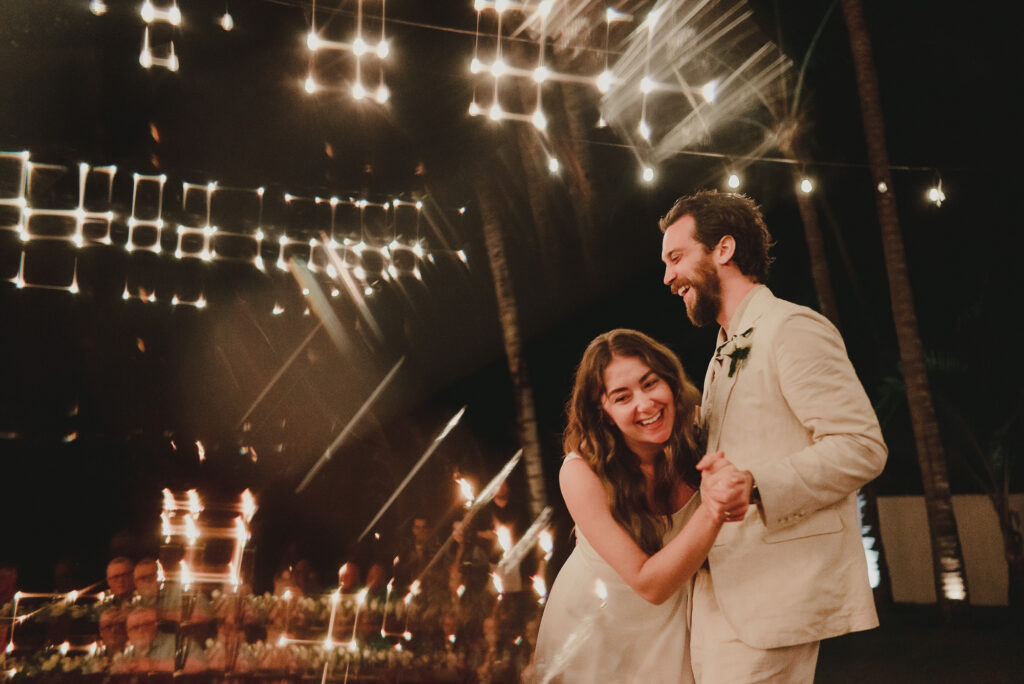 Couple sharing first dance under string lights at Frente al Punto wedding reception in Sayulita, Mexico