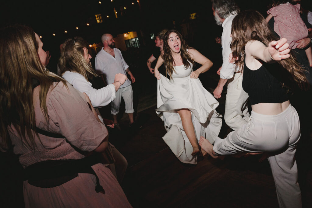 Bride dancing barefoot with guests at outdoor wedding reception, Frente al Punto, Sayulita