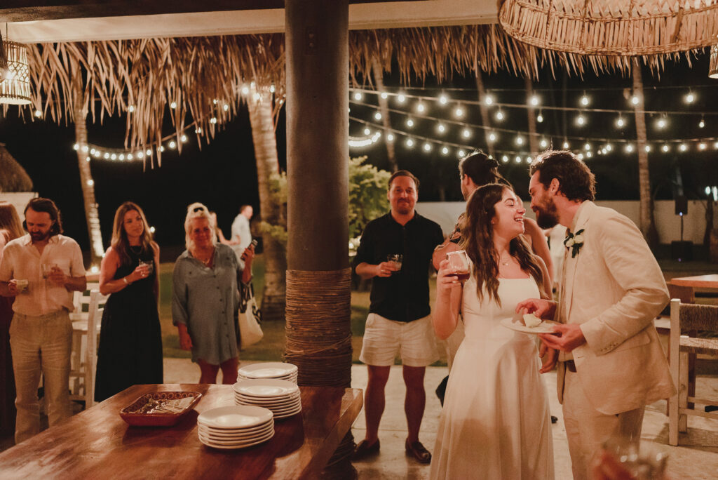 Bride and groom laughing together at outdoor wedding reception at Frente al Punto, Sayulita, Mexico