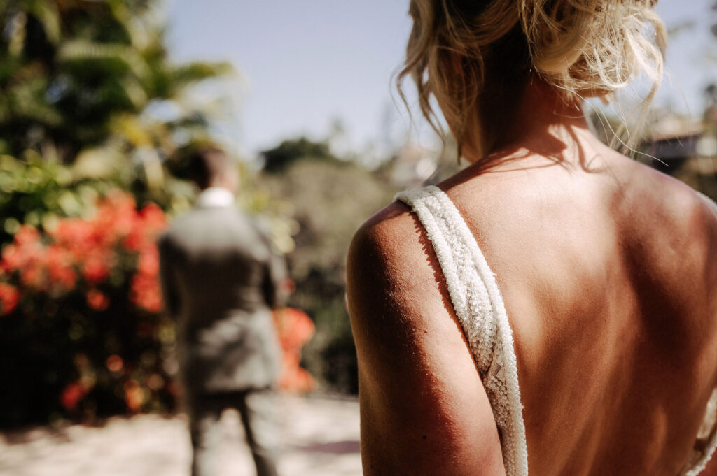 Bride in open-back beaded gown faces groom at Villa Amor Sayulita wedding ceremony