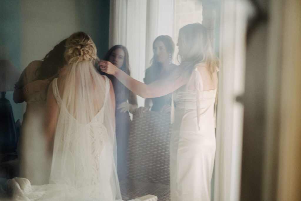 Bride getting veil pinned by bridesmaids before ceremony at Villa Amor, Sayulita wedding