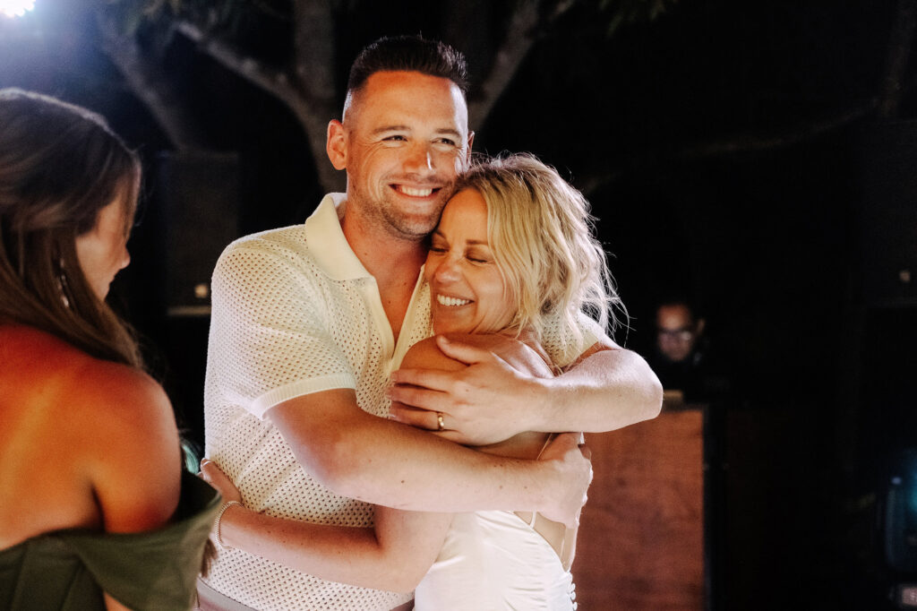 Couple sharing a joyful embrace during wedding reception at Villa Amor Sayulita, Mexico