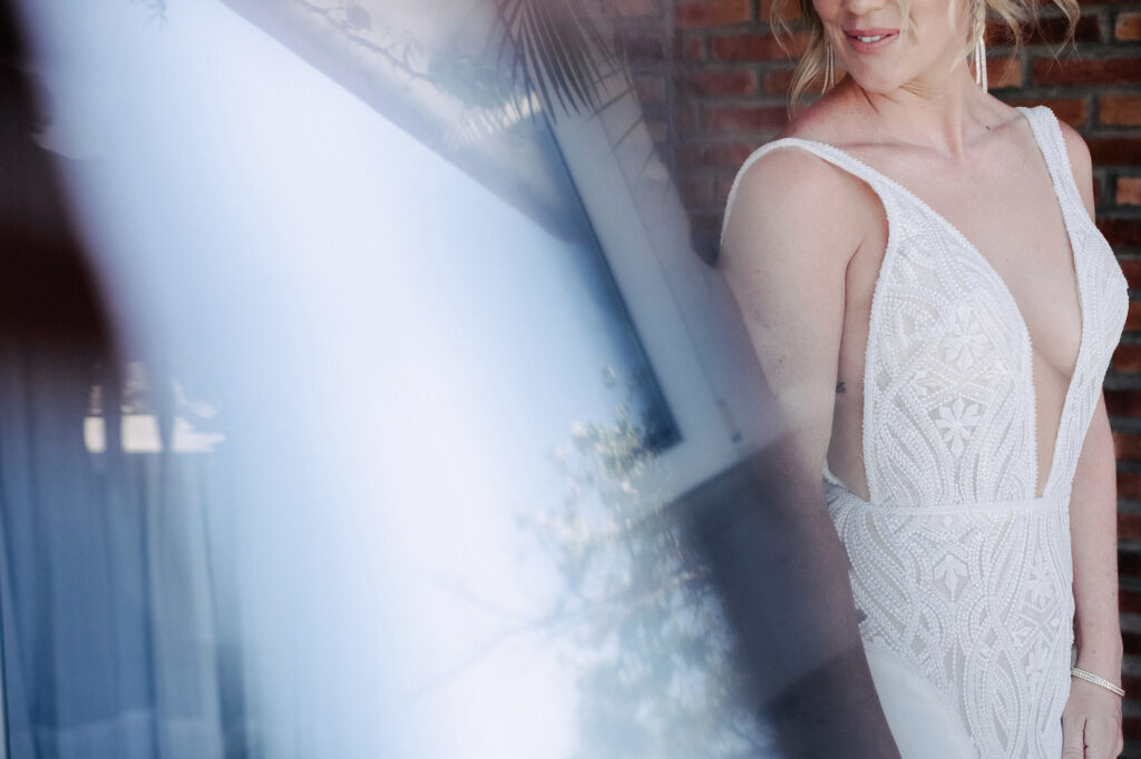 Bride in beaded deep V-neck gown at Villa Amor Sayulita, documentary wedding photography by Alex Obregón