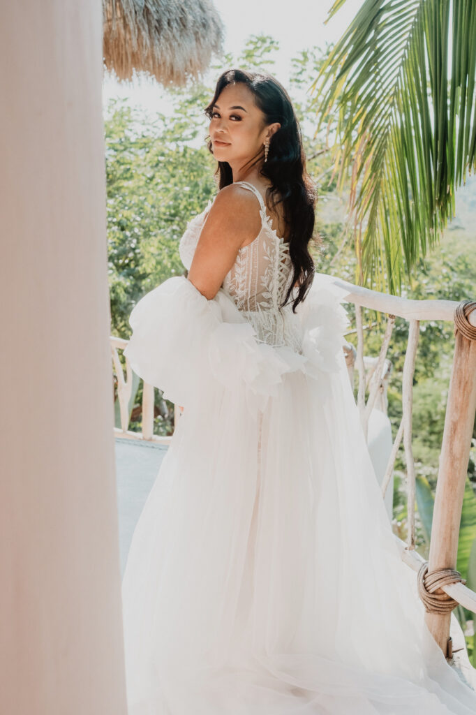Bride in lace bodice ballgown with oversized bow at Villa Valentin Sayulita wedding ceremony