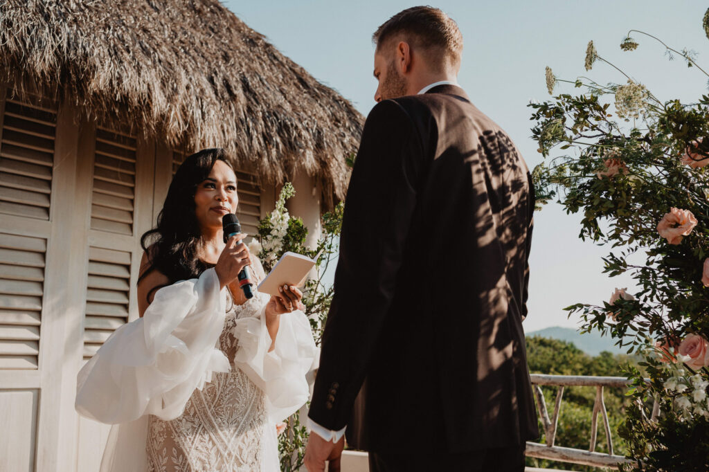 Bride reads vows to groom at outdoor wedding ceremony, Villa Valentin Sayulita Mexico