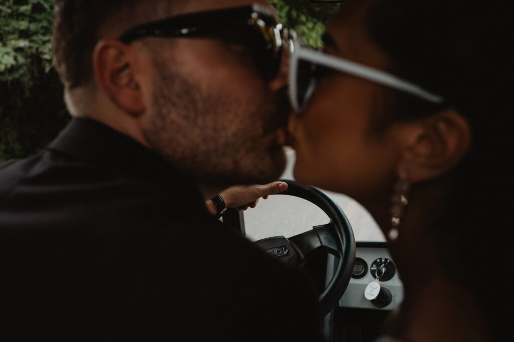 Couple sharing a kiss in a golf cart at Villa Valentin Sayulita wedding reception, documentary style