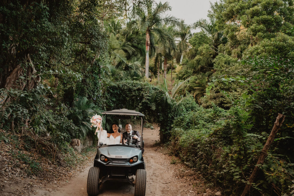 Bride and groom riding golf cart through jungle path at Villa Valentin Sayulita wedding