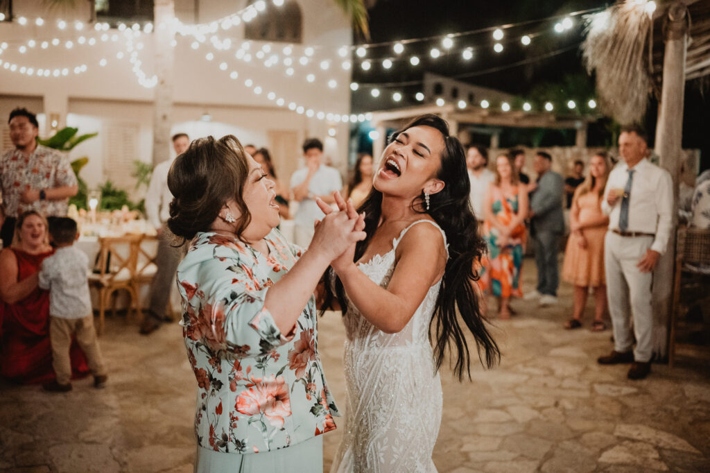 Bride laughing while dancing with family member at wedding reception, Villa Valentin, Sayulita