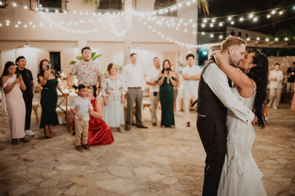 Bride and groom share first dance kiss at Villa Valentin Sayulita wedding reception under string lights