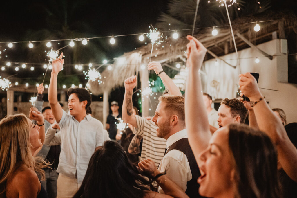 Wedding guests celebrating with sparklers at night reception, Villa Valentin Sayulita, documentary wedding photography