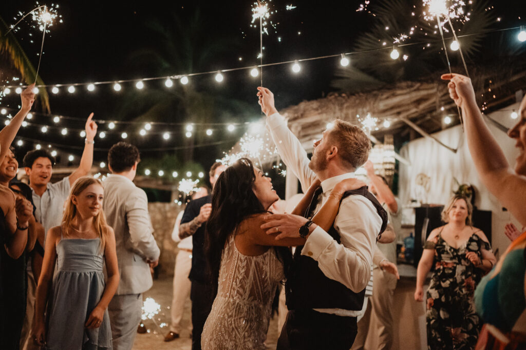 Bride and groom sparkler exit at Villa Valentin Sayulita wedding reception, surrounded by cheering guests