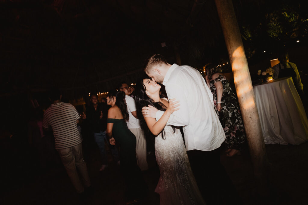 Bride and groom sharing a kiss on the dance floor at Villa Valentin wedding reception, Sayulita Mexico